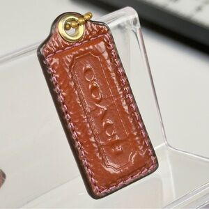 Coach brown and purple patent Leather Tag with chain purple thread